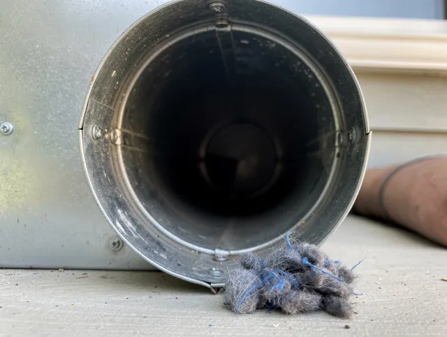 Alafaya Dryer Vent Cleaning technician using specialized equipment to clear severe dryer vent blockage in Alafaya